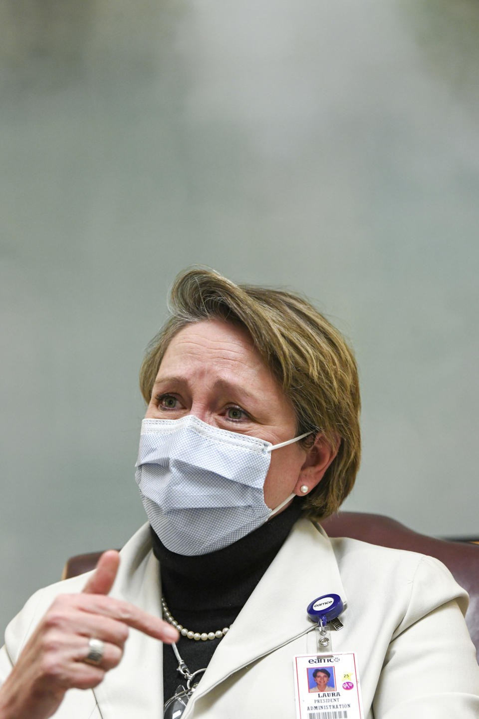 Laura Grill, chief executive officer of East Alabama Medical Center, becomes emotional while speaking of COVID-19 patients and the medical staff tending to them Thursday, Dec. 10, 2020, in Opelika, Ala. COVID-19 patients occupy most of the beds in ICU in addition to the non-critical patients on the seventh floor. (AP Photo/Julie Bennett)