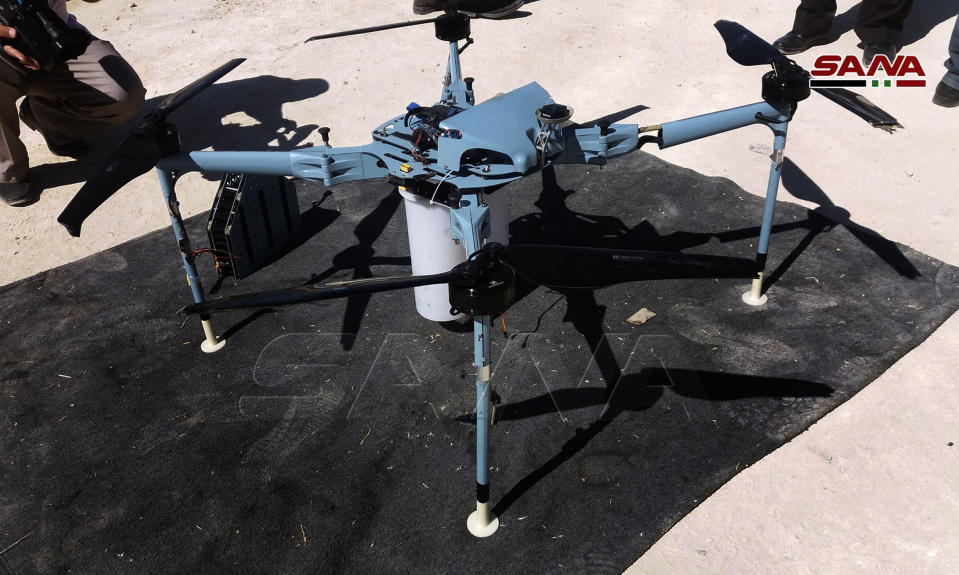 In this photo released by the Syrian official news agency SANA, shows a drone which the Syrian state news agency says authorities have controlled and dismantled was rigged with cluster bombs on the edge of the Israeli-occupied Golan Heights, southern Syria, Saturday, Sept. 21, 2019. (SANA via AP)