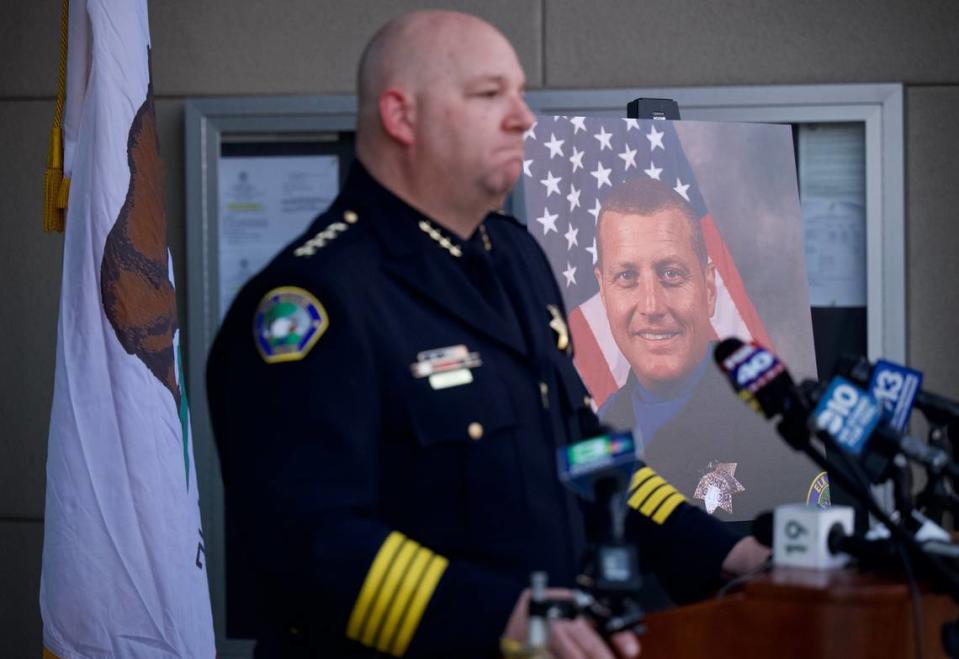 Elk Grove Police Chief Timothy Albright speaks at a press conference outside the Police Department about death of officer Tyler Lenehan, pictured at right, on Friday, Jan. 21, 2022. Lenehan died earlier in the day in a wrong-way crash on Highway 99.