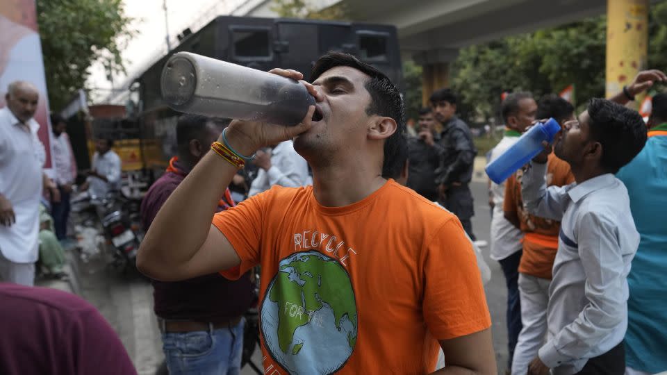 A man drinks water at a roadside stall serving free drinking water to commuters in New Delhi on May 22. - Manish Swarup/AP