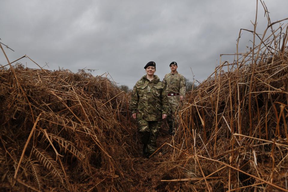 British army officers walk on a WW1 practise trench as they pose for the photographers in Gosport, southern England, Thursday, March 6, 2014. This overgrown and oddly corrugated patch of heathland on England’s south coast was once a practice battlefield, complete with trenches, weapons and barbed wire. Thousands of troops trained here to take on the Germany army. After the 1918 victory _ which cost 1 million Britons their lives _ the site was forgotten, until it was recently rediscovered by a local official with an interest in military history. Now the trenches are being used to reveal how the Great War transformed Britain _ physically as well as socially. As living memories of the conflict fade, historians hope these physical traces can help preserve the story of the war for future generations. (AP Photo/Lefteris Pitarakis)
