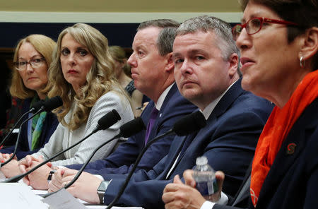 USOC acting chief Susanne Lyons, USA Gymnastics CEO Kerry Perry, Tim Hinchey, President and CEO of USA Swimming, Steve McNally, Executive Director, USA Taekwondo and Shellie Pfohl, CEO, U.S. Center for SafeSport prepare to testify at a House Energy and Commerce Committee hearing on Olympic athletes and sexual abuse on Capitol Hill in Washington, U.S., May 23, 2018. REUTERS/Jonathan Ernst