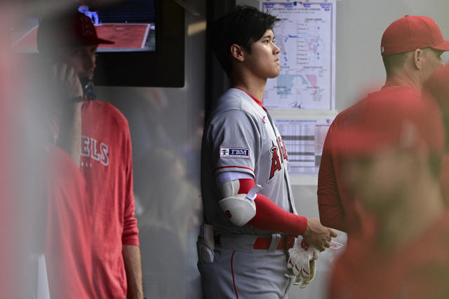 Los Angeles Angels' Shohei Ohtani stands in the dugout during the seventh inning of the team's baseball game against the Cleveland Guardians, Saturday, May 13, 2023, in Cleveland. (AP Photo/David Dermer)