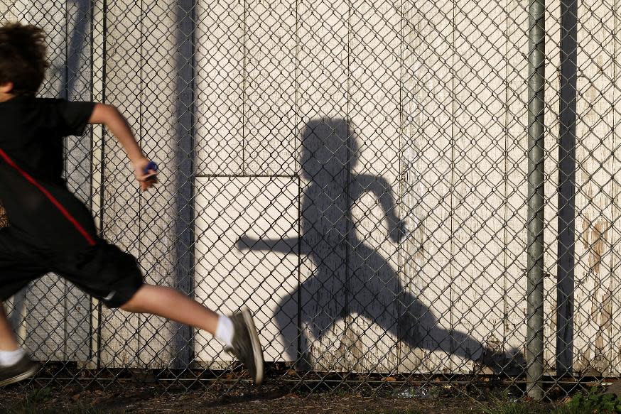 In this March 14, 2014 picture, students take part in an early morning running program at an elementary school in Chula Vista, Calif. Amid alarming national statistics showing an epidemic in childhood obesity, hundreds of thousands of students across the country are being weighed and measured. The Chula Vista Elementary School District is being touted as a model for its methods that have resulted in motivating the community to take action. (AP Photo/Gregory Bull)