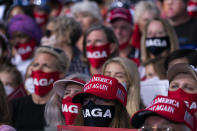 Supporters of President Donald Trump listen as he speaks during a campaign rally at Cecil Airport, Thursday, Sept. 24, 2020, in Jacksonville, Fla. (AP Photo/Evan Vucci)