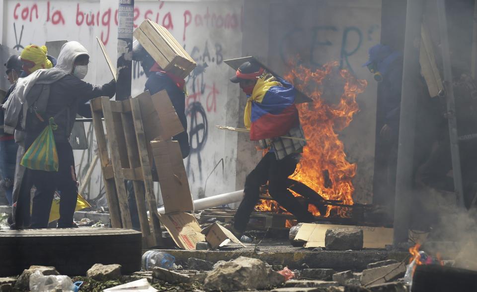 Anti-government demonstrator clash with police in Quito, Ecuador, Saturday, Oct. 12, 2019. Protests, which began when President Lenin Moreno's decision to cut subsidies led to a sharp increase in fuel prices, have persisted for days. (AP Photo/Fernando Vergara)