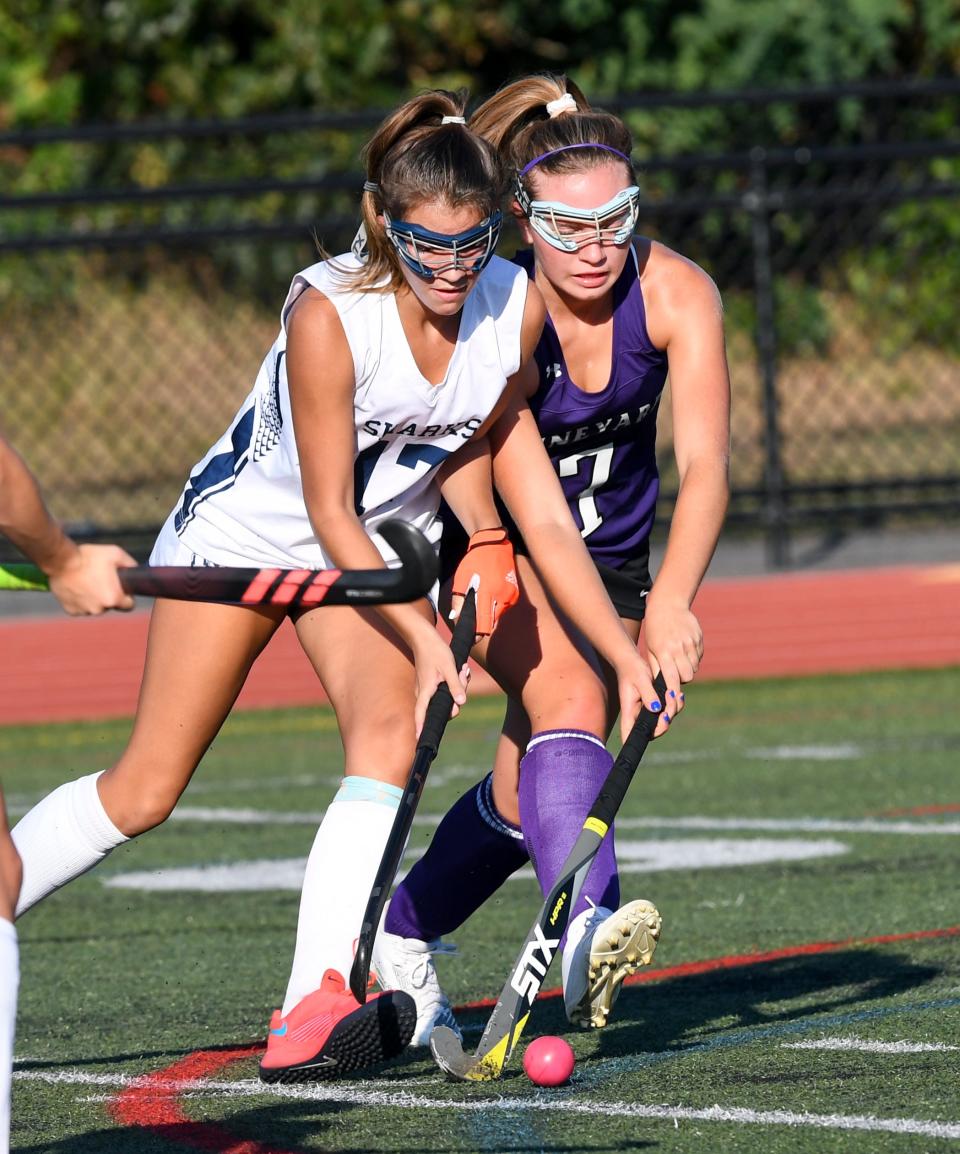 Emily Layton of Monomoy, left, and Cali Giglio of Martha's Vineyard struggle for possession of the ball.