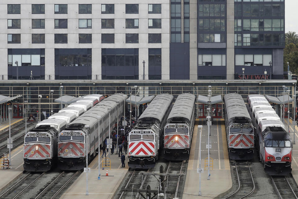 FILE - This Wednesday, Oct. 16, 2019, file photo shows trains at a Caltrain station in San Francisco. Transit systems have seen fare collections evaporate amid stay-at-home orders amid the coronavirus pandemic. Officials at Caltrain, a Bay area commuter rail line, said that they may have to end service after San Francisco supervisors blocked a tax increase to increase its subsidy. (AP Photo/Jeff Chiu, File)
