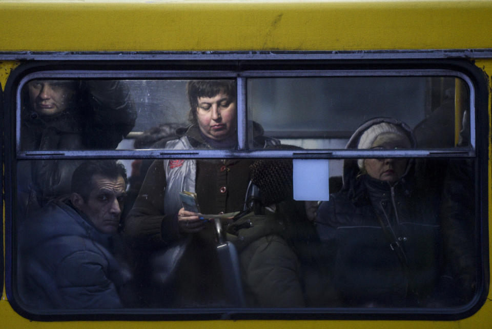 People ride a bus in Mariupol, south coast of Azov sea, eastern Ukraine, Friday, Nov. 30, 2018. (AP Photo/Evgeniy Maloletka)