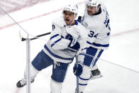 Toronto Maple Leafs center Max Domi (11) celebrates after his goal against Boston Bruins goaltender Linus Ullmark during the first period of Game 2 of an NHL hockey Stanley Cup first-round playoff series, Monday, April 22, 2024, in Boston. Maple Leafs center Auston Matthews, right, looks on. (AP Photo/Charles Krupa)