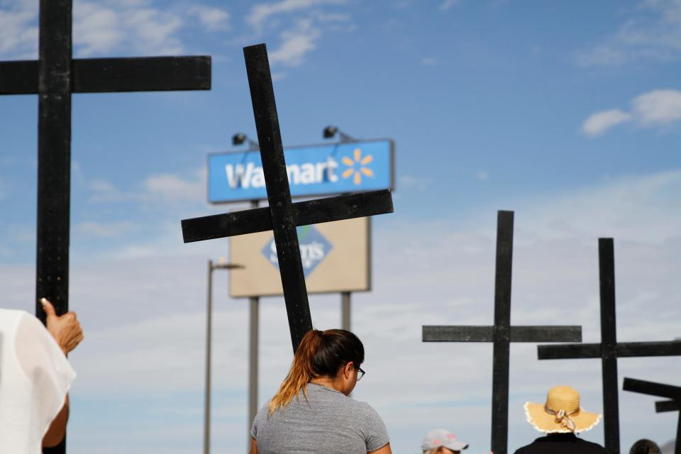 Volunteers with Border Network for Human Rights carry crosses with the names of the 23 victims of the Walmart shooting during a procession from Ponder Park to Walmart during a remembrance on the fourth anniversary of the mass shooting from August 3, 2019.