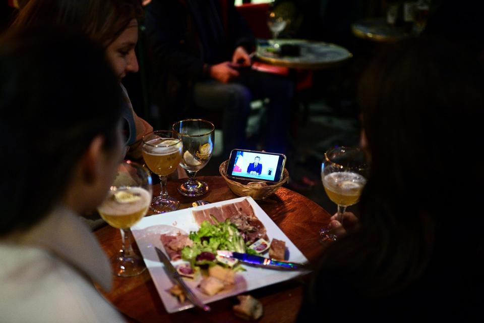 "Glasses were put down and cigarettes temporarily stubbed as the livestream from the Elysée, broadcast from less than a mile away, echoed between smartphones" - getty