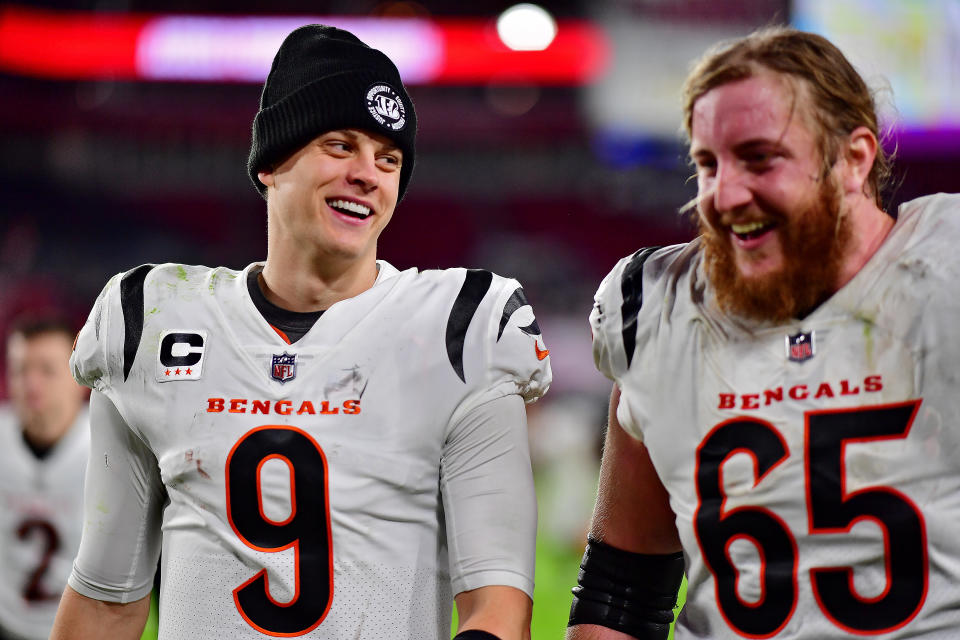 TAMPA, FLORIDA – DECEMBER 18: Joe Burrow #9 and Alex Cappa #65 of the Cincinnati Bengals on the field after a win over the Tampa Bay Buccaneers at Raymond James Stadium on December 18, 2022 in Tampa, Florida. (Photo by Julio Aguilar/Getty Images)