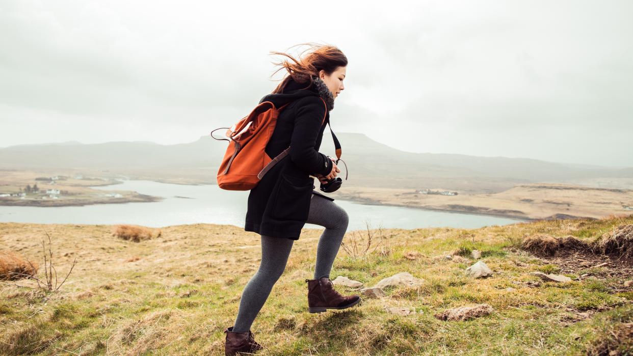  A young girl hiking alone in the wind  