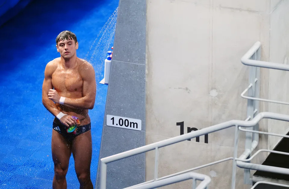 Great Britain’s Tom Daley stands near a pool.