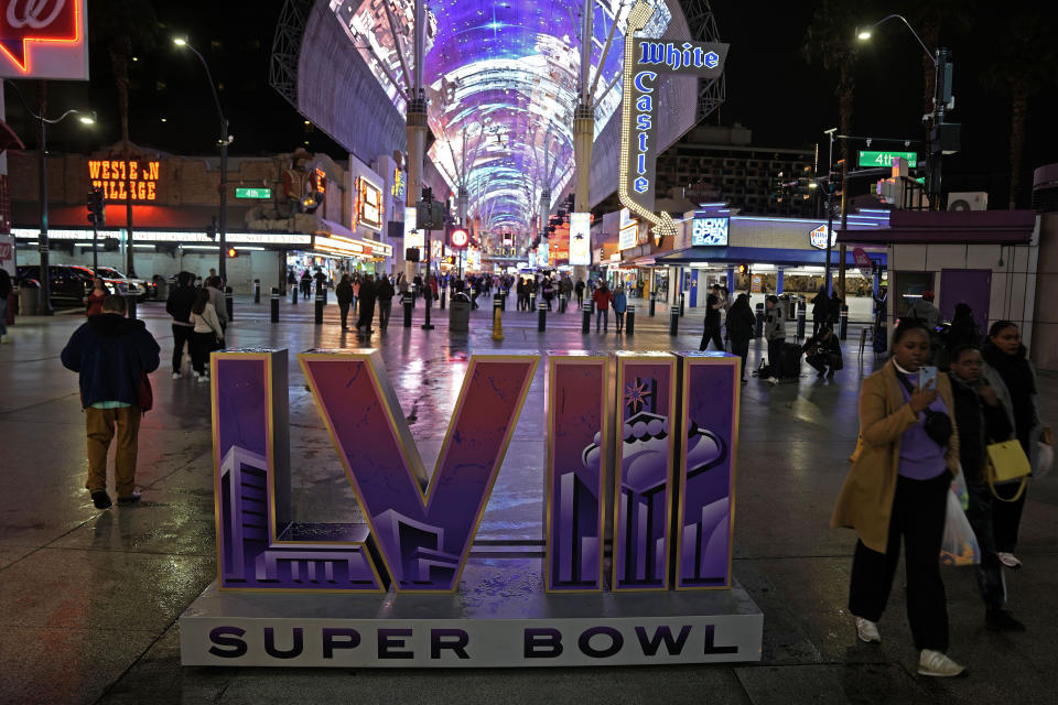People walk past a sign for Super Bowl 58 at the Fremont Street Experience Tuesday, Feb. 6, 2024 in Las Vegas. The Kansas City Chiefs are scheduled to play the San Francisco 49ers in the NFL's Super Bowl 58 football game Sunday. (AP Photo/Charlie Riedel)