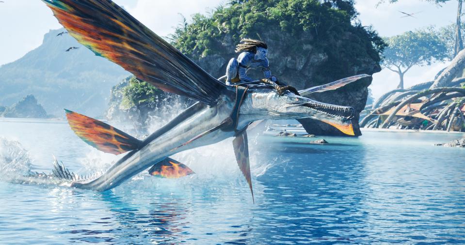Jake Sully (Sam Worthington) rides high on the sea in James Cameron's sci-fi sequel &quot;Avatar: The Way of  Water.&quot;