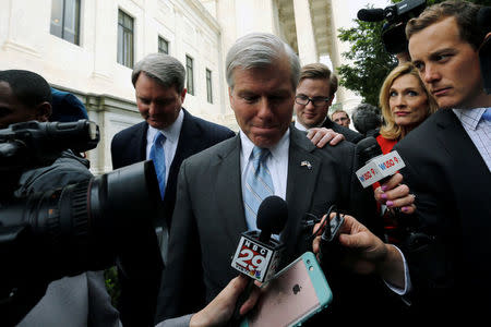 Former Virginia Governor Bob McDonnell is trailed by reporters as he departs after his appeal of his 2014 corruption conviction was heard at the U.S. Supreme Court in Washington, U.S. April 27, 2016. REUTERS/Jonathan Ernst