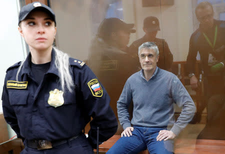 Founder of the Baring Vostok private equity group Michael Calvey, who was detained on suspicion of fraud, sits inside a defendants' cage as he attends a court hearing in Moscow, Russia February 15, 2019. REUTERS/Tatyana Makeyeva