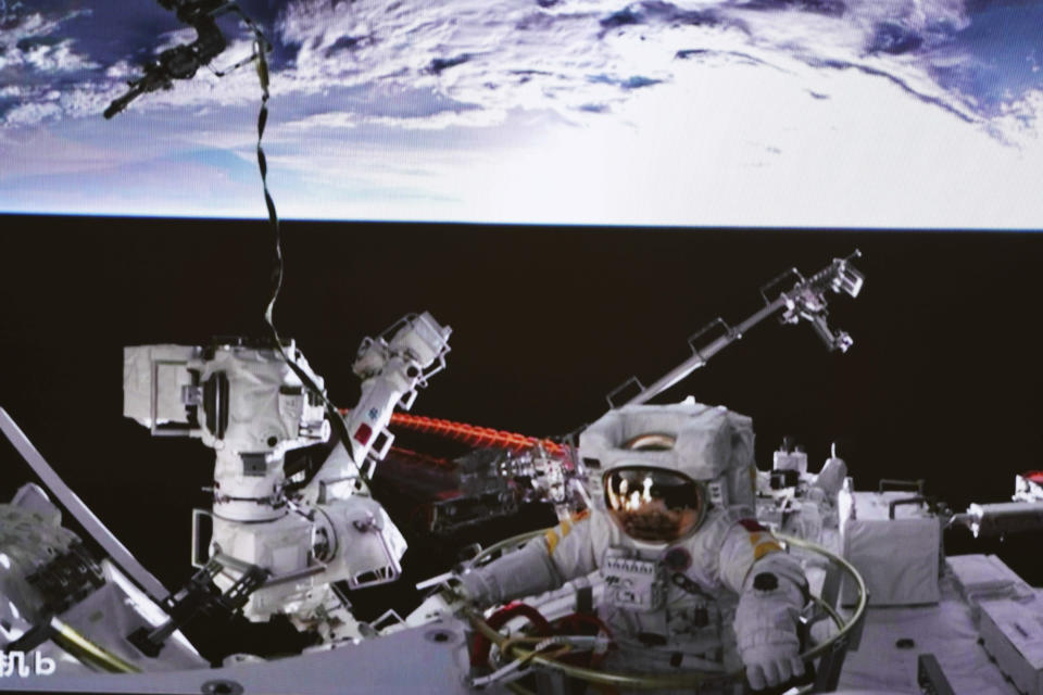 In this photo released by China's Xinhua News Agency, a screen at the Beijing Aerospace Control Center in Beijing shows Chinese astronaut Cai Xuzhe exiting the station lab module Wentian to conduct extravehicular activities, also known as a spacewalk, Saturday, Sept. 17, 2022. (Guo Zhongzheng/Xinhua via AP)