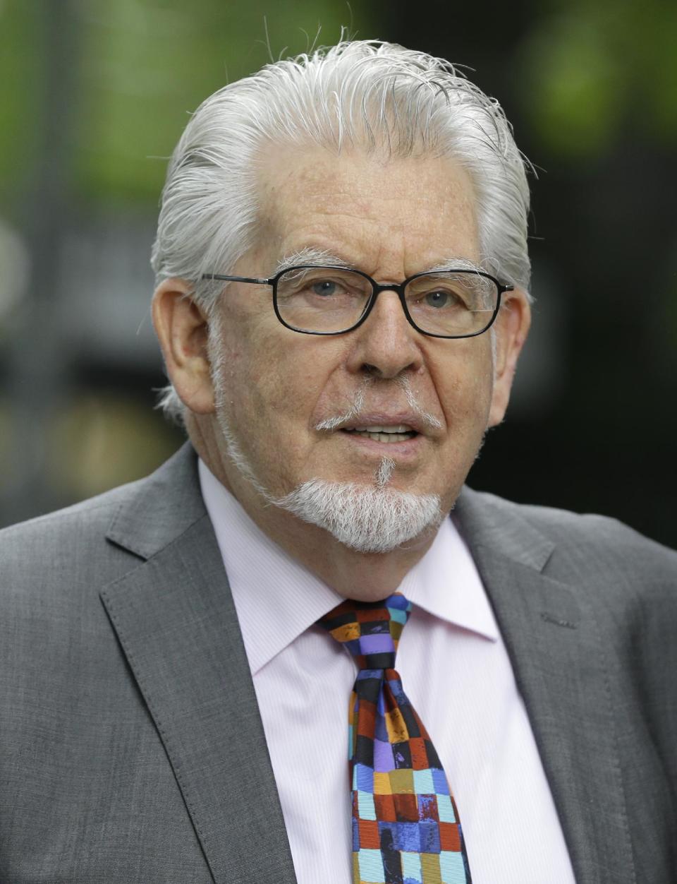 Veteran Australian-British entertainer Rolf Harris who is accused of indecent assault arrives at Southwark Crown Court in London, Friday, May 9, 2014. The 84-year-old is charged with indecently assaulting four girls between 1968 and 1986. The girls ranged in age from 7 or 8 to 19. Harris denies the charges. (AP Photo/Kirsty Wigglesworth)