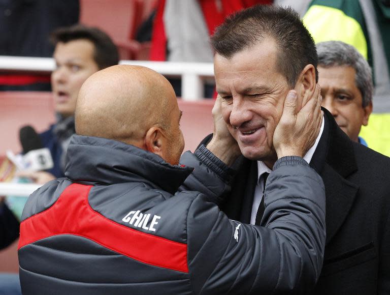 Brazil's coach Dunga (R) greets Chile's coach Jorge Sampaoli (L) ahead of the friendly international football match in London on March 29, 2015