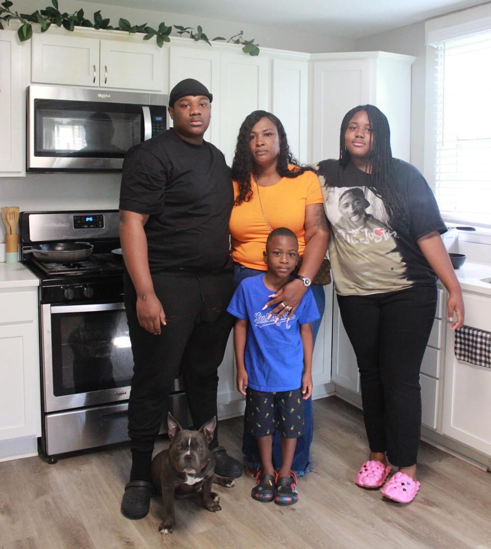Shanika Henderson, center,  poses with her family, from left, 17yr old son Montique, 5yr old son Graceson, 12yr old daughter Kaylah, with Humphrey the dog. (Michelle Cho / NBC News)