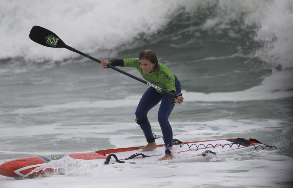 Brazil's Lena Guimaraes paddles to win the gold medal in the women's SUP race final during the Pan American Games on Punta Rocas beach in Lima Peru, Friday, Aug.2, 2019. (AP Photo/Silvia Izquierdo)