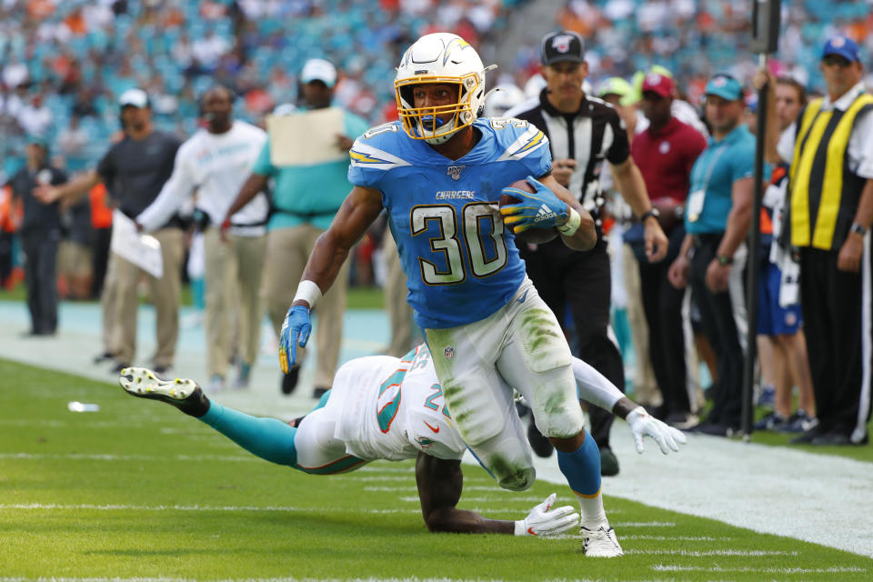Miami Dolphins free safety Reshad Jones (20) misses a tackles as Los Angeles Chargers running back Austin Ekeler (30) runs for a touchdown, during the first half at an NFL football game against the Miami Dolphins, Sunday, Sept. 29, 2019, in Miami Gardens, Fla. (AP Photo/Wilfredo Lee)