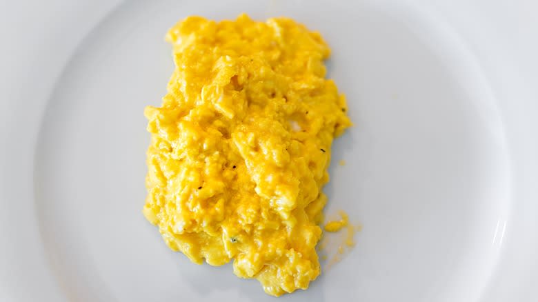 Scrambled eggs on white plate 