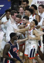 Virginia players celebrate in front of Auburn forward Danjel Purifoy (3) after a semifinal round game in the Final Four NCAA college basketball tournament, Saturday, April 6, 2019, in Minneapolis. (AP Photo/Matt York)