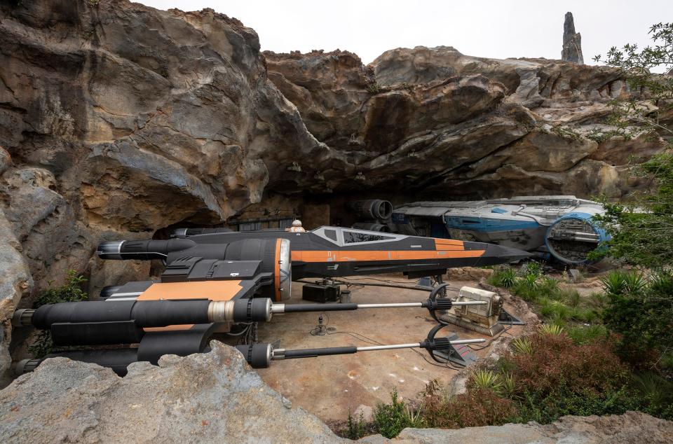 Guests see Poe Dameron’s X-wing starfighter, Black One (foreground), and board an Intersystem Transport Ship (background) as part of Star Wars: Rise of the Resistance. The new attraction, which opened Dec. 5 inside Star Wars: Galaxy’s Edge at Disney’s Hollywood Studios in Florida and opens Jan. 17 at Disneyland Park in California, takes guests into a climactic battle between the Resistance and the First Order.