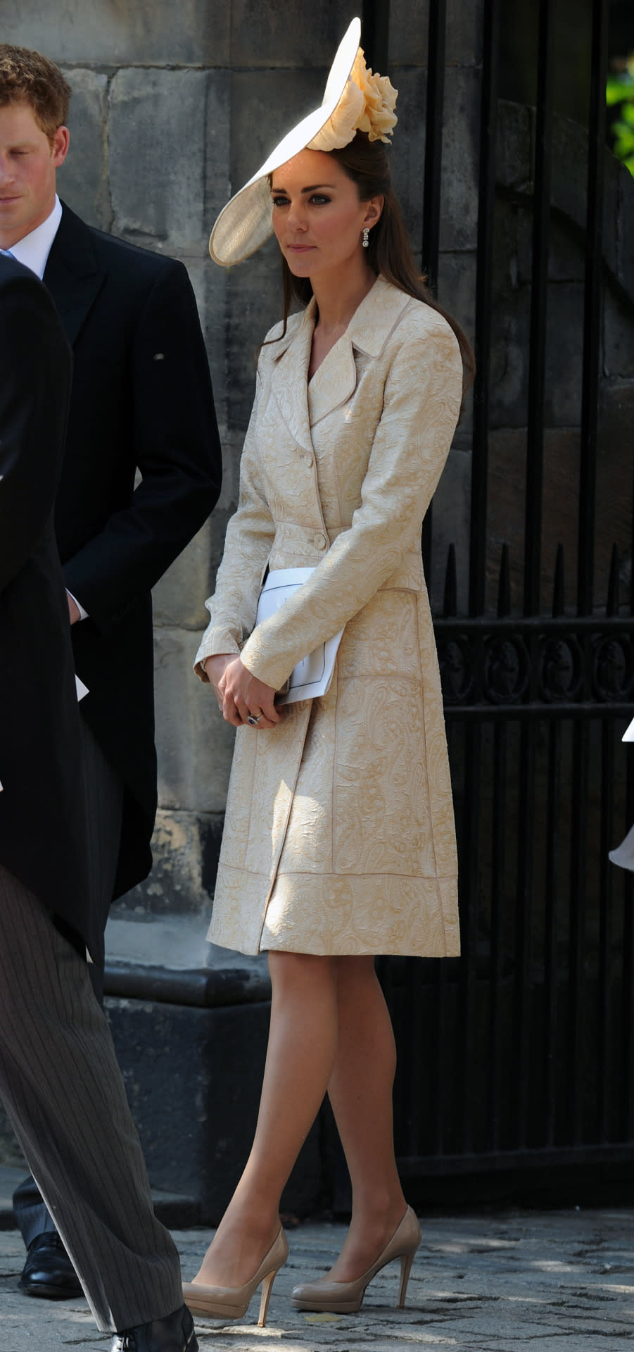 <p>For Zara Phillips’ wedding to Mike Tindall, Kate donned a gold brocade coat by Day Birger et Mikkelsen and a large hat designer by Gina Foster. Her shoes and bag were both from L.K. Bennett.</p><p><i>[Photo: PA]</i></p>