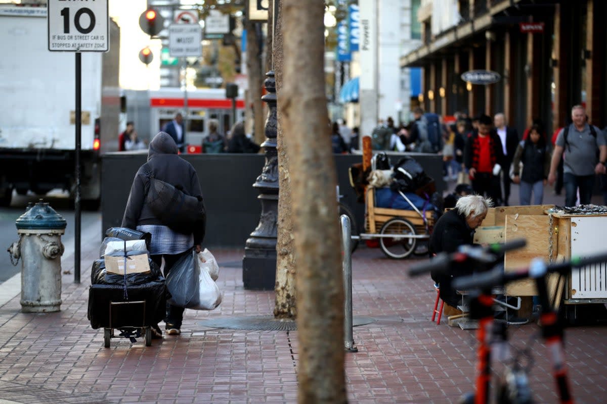 A homeless man pulls a cart with his belongings in San Francisco, California (Getty Images)