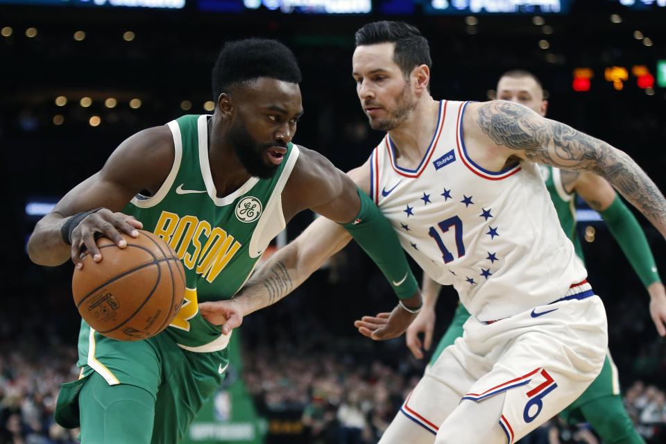 Boston Celtics' Jaylen Brown (7) is defended by Philadelphia 76ers' JJ Redick (17) during the first half of an NBA basketball game in Boston, Tuesday, Dec. 25, 2018. (AP Photo/Michael Dwyer)