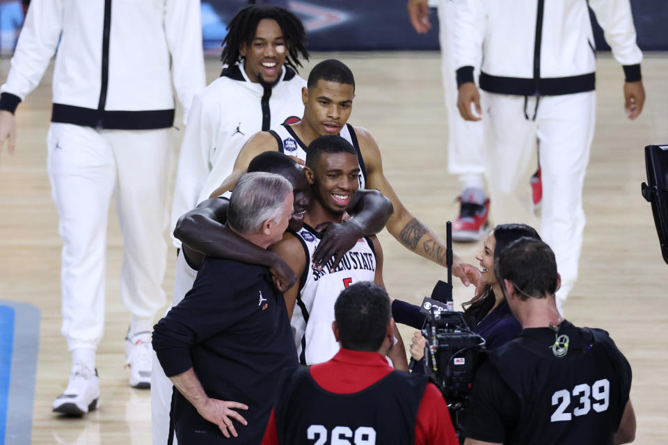 April 1, 2023; Houston, Texas; San Diego State Aztecs guard Lamont Butler (5) celebrates with San Diego State Aztecs head coach Brian Dutcher (left) and San Diego State Aztecs forward Aguek Arop (33) after defeating the Florida Atlantic Owls in the semifinals of the Final Four of the 2023 NCAA Tournament at NRG Stadium. Troy Taormina-USA TODAY Sports