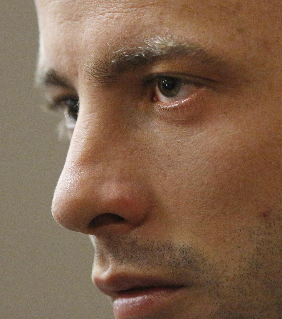 Oscar Pistorius appears in the dock on the second day of his trial at the high court in Pretoria, South Africa, Tuesday, March 4, 2014. Pistorius is charged with murder for the shooting death of his girlfriend, Reeva Steenkamp, on Valentine's Day in 2013. (AP Photo/Kim Ludbrook,Pool)