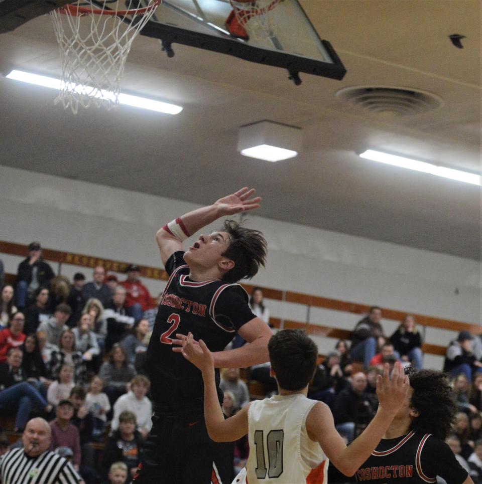 Coshocton's Colton Conkle lays the ball up over Ridgewood's Jackson Cabot in last year's game of the Holiday Classic at River View. Conkle anchors a strong returning lineup for the Redskins, who aim to compete for the MVL Small School Division title.