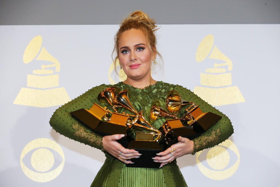 Adele holds the five Grammys she won including Record of the Year for “Hello” and Album of the Year for “25” during the 59th Annual Grammy Awards in Los Angeles, California, U.S. , February 12, 2017. REUTERS/Mike Blake TPX IMAGES OF THE DAY