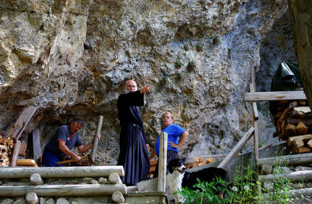 Hermit Stan Vanuytrecht of Belgium talks to workers outside his hermitage in Saalfelden, Austria, May 22, 2017. Picture taken May 22, 2017. REUTERS/Leonhard Foeger