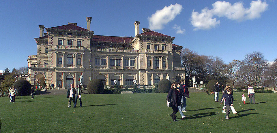 FILE - In this Nov. 12, 2001 file photo, visitors take advantage of free admission to tour The Breakers mansion in Newport, R.I. The Preservation Society of Newport County proposed building a visitor center in 2014 that would sit on the mansion's grounds. The society said it would be unobtrusive and would provide necessary services that currently are lacking at the popular tourist attraction. Some nearby residents are fighting the plan. (AP Photo/Stew Milne, File)