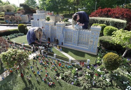 FILE PHOTO: A LEGO Windsor Castle replete with the upcoming wedding between Britain's Prince Harry and Meghan Markle, is worked on by staff at Legoland, in Windsor