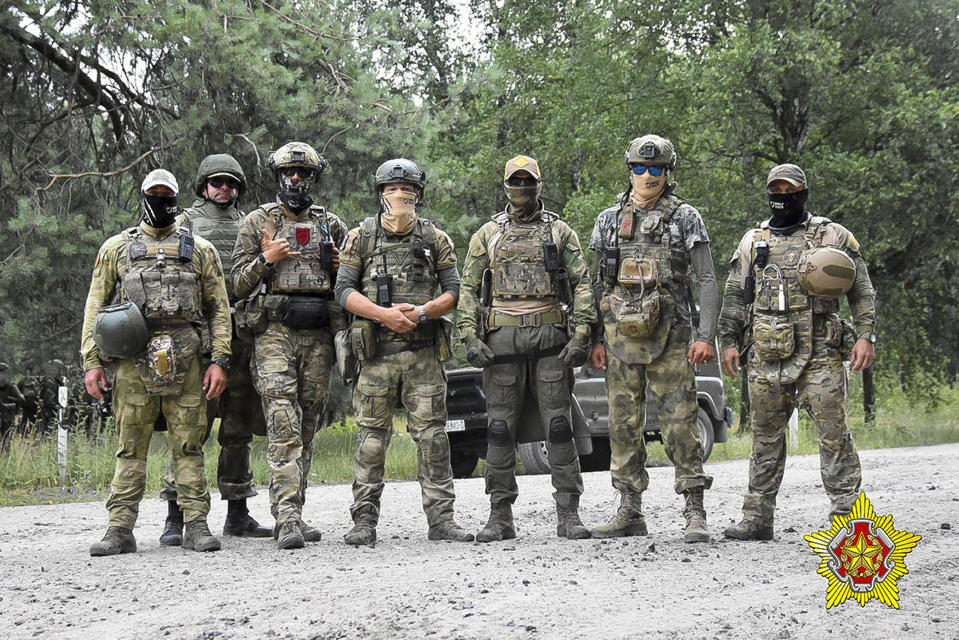 In this photo released by Belarus' Defense Ministry on Thursday, July 20, 2023, Belarusian soldiers of the Special Operations Forces (SOF) and mercenary fighters from Wagner private military company pose for a photo while the weeklong maneuvers that will be conducted at a firing range near the border city of Brest, Belarus. Mercenaries from Russia's military company Wagner have launched joint drills with the Belarusian military near the border with Poland following their relocation to Belarus after their short-lived rebellion. (Belarus' Defense Ministry via AP)