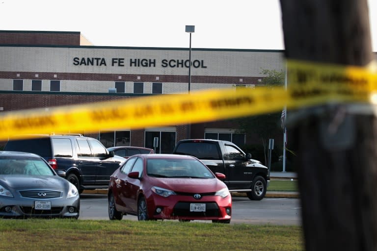 Crime scene tape stretched outside Santa Fe High School, where 10 people, most of them students, were killed by a classmate