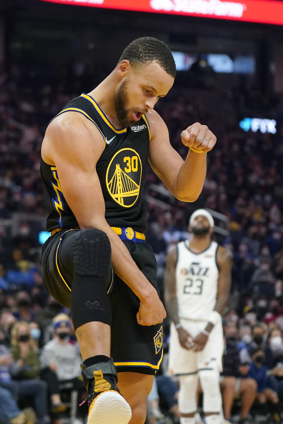 Golden State Warriors guard Stephen Curry celebrates after scoring against the Utah Jazz during the first half of an NBA basketball game in San Francisco, Sunday, Jan. 23, 2022. (AP Photo/Jeff Chiu)