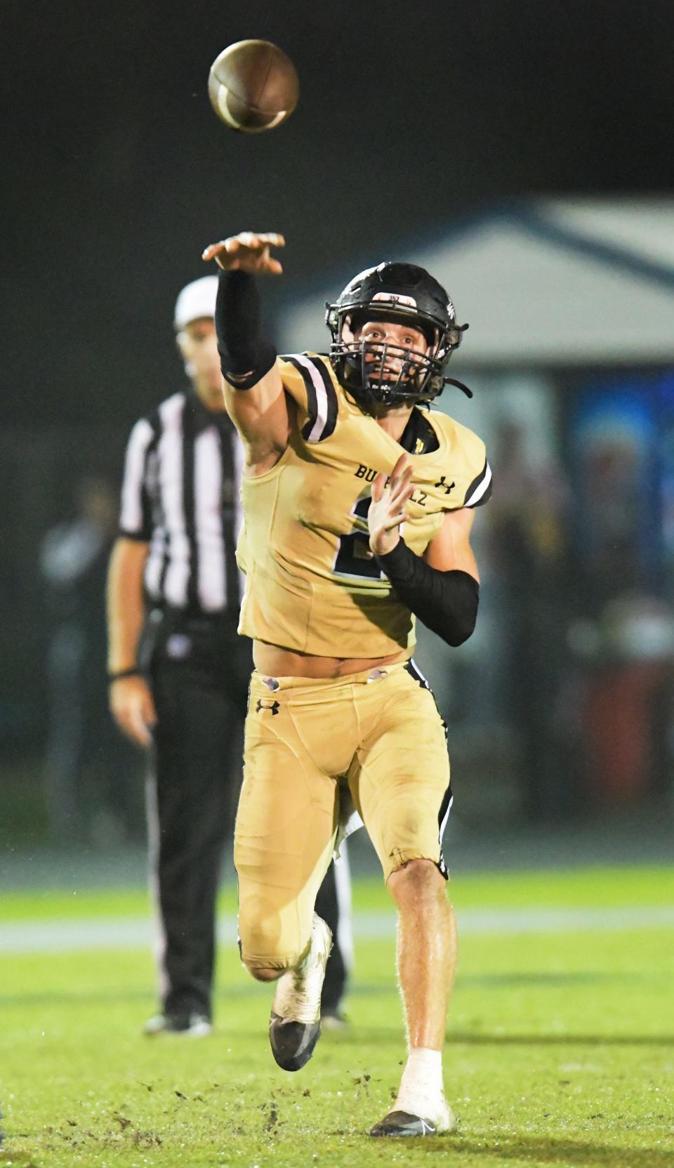 Buchholz's quarterback Creed Whittemore (2) launches a pass for a first down to teammate RJ Livingston (13) as the clock ran out on the first quarter. The Bartram Trail Bears football team hosted Gainesville's Buchholz Bobcats at the Bears Saint Johns stadium Friday, November 25, 2022. With the Buchholz's Friday night 21 to 20 win in the FHSAA Region 1-4S high school football final, the Bobcats's advance to the final four.