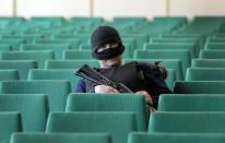 A gunman guards during a press conference of Vacheslav Ponomarev, leader of the pro-Russian gunmen, in city hall, Slovyansk, eastern Ukraine, Sunday, April 20, 2014. Pro-Russian insurgents defiantly refused to surrender their weapons or give up government buildings in eastern Ukraine, despite a diplomatic accord reached in Geneva and overtures from the government in Kiev. (AP Photo/Efrem Lukatsky)