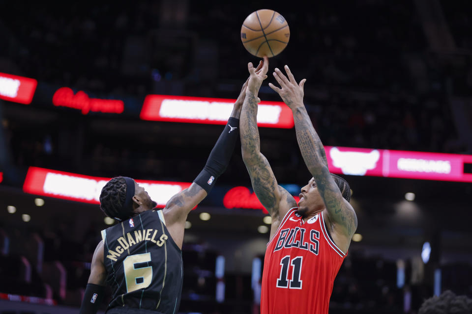 Chicago Bulls forward DeMar DeRozan (11) shoots against Charlotte Hornets forward Jalen McDaniels (6) during the first half of an NBA basketball game in Charlotte, N.C., Thursday, Jan. 26, 2023. (AP Photo/Nell Redmond)