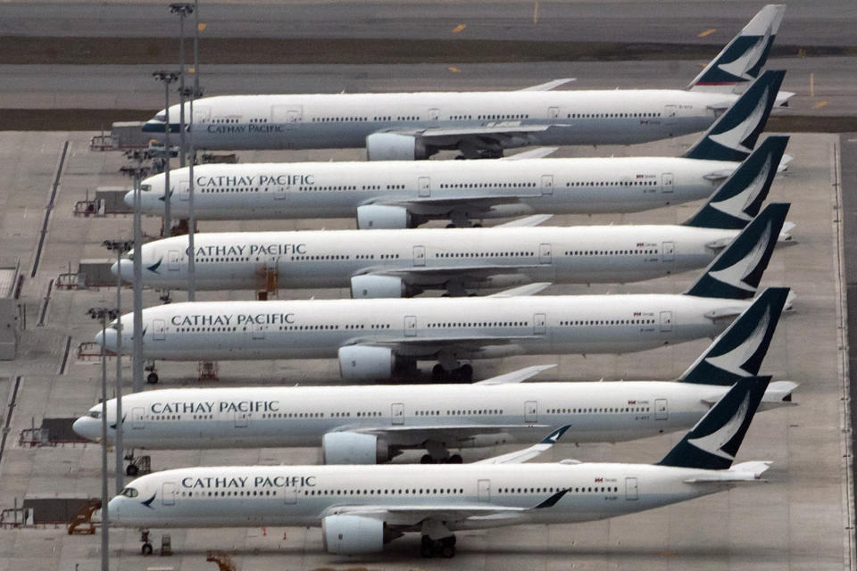 FILE - In this March 6, 2020, file photo, Cathay Pacific Airways aircraft line up on the tarmac at the Hong Kong International Airport. Financially battered Hong Kong airline Cathay Pacific Airways says it is proposing the government help fund a $5 billion recapitalization plan to help it recover from the coronavirus pandemic. (AP Photo/Kin Cheung)