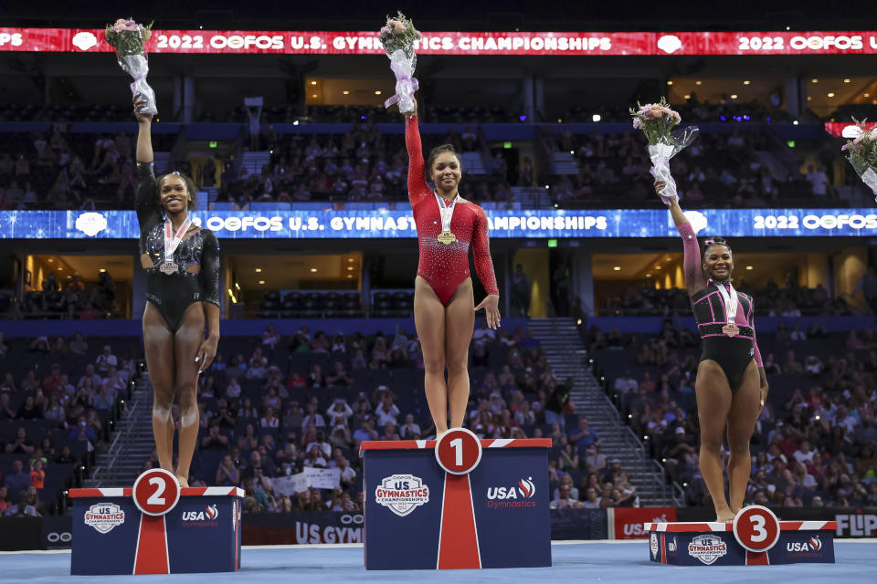 Konnor McClain, center, celebrates her first place overall finish with second place winner Shilese Jones, left, and third place winner Jordan Chiles during the U.S. Gymnastics Championships Sunday, Aug. 21, 2022, in Tampa, Fla.(AP Photo/Mike Carlson)